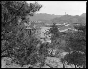 Looking through trees at the parade ground and barracks, Yamaguchi, Japan