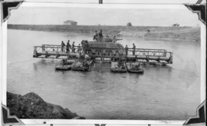 New Zealand soldiers transporting a tank over the Po River, Italy, during World War 2