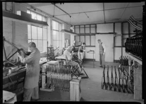 Factory workers joining metal frames