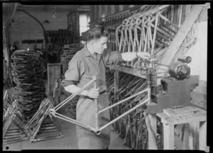 Factory worker pressing metal structure