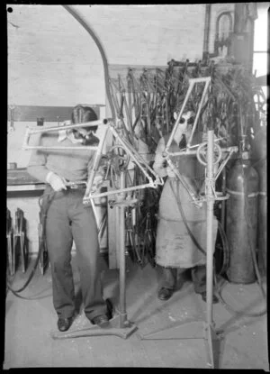 Factory workers welding frames
