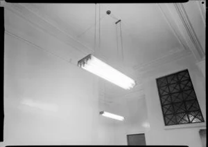 Fluorescent lighting fixture suspended from ceiling