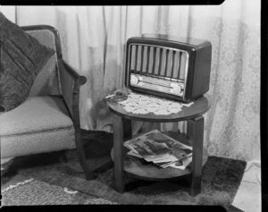 Mantel radio on coffee table next to armchair