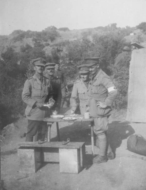 Four soldiers standing eating at a table, Gallipoli, Turkey