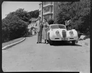 Couple beside car on Oriental Parade, Wellington