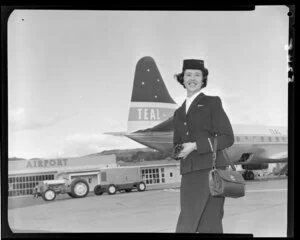 Air hostess [Miss Clark] in front of Teal plane
