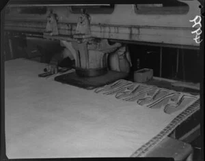 Man stamping outsoles at Buchanan and Edwards shoe factory