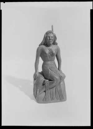 Maori souvenir - wahine seated on rock