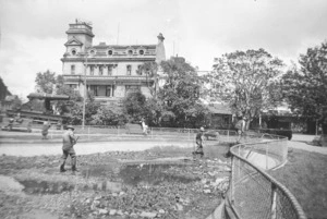 Workers in a pond, and the Grand Hotel, The Square, Palmerston North