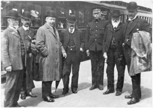 Unidentified group of men on a railway platform, Wellington-Manawatu line