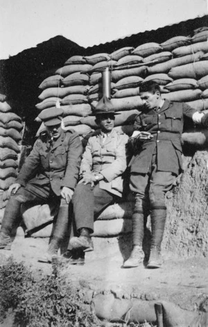 Three soldiers photographed against a wall of sandbags, Gallipoli, Turkey