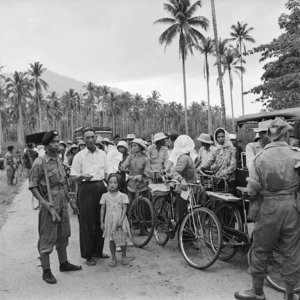 Unidentified group waiting to be checked into a village, Malaya