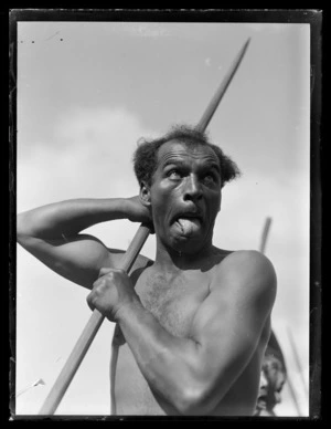 Unidentified Maori warrior leading a haka, holding a taiaha