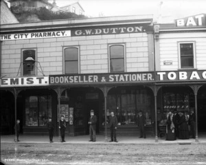 View of the businesses of the City Pharmacy and G W Dutton, Lambton Quay, Wellington
