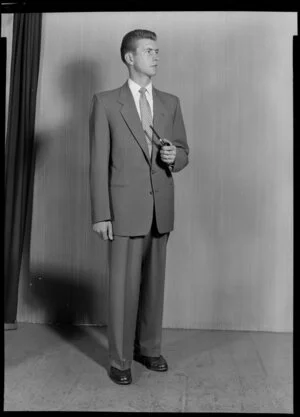 Man modelling suit with pipe