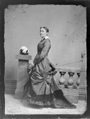 Unidentified woman, wearing fancy bustle dress with trimmings