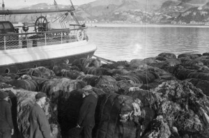 Zachariah, Joseph, 1867-1965 :Bales of water damaged wool alongside the ship Jessie Osborne, Wellington