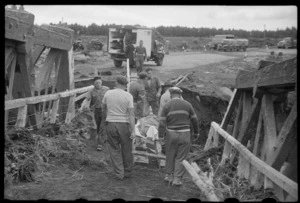 Rescue party carrying a body on a stretcher at the scene of the railway disaster at Tangiwai