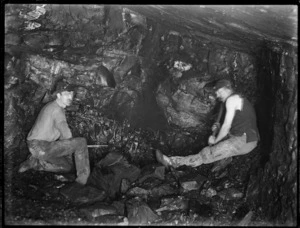 Two miners in a coal mine