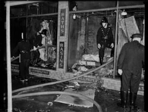 Firemen in burnt-out windows of Smith and Smith Ltd, Cuba Street, Wellington