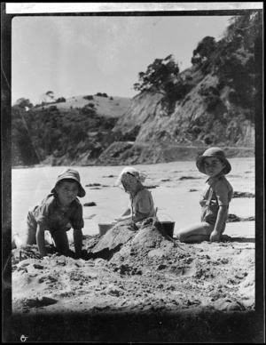 Robert Wells and Hunt children making sandcastles