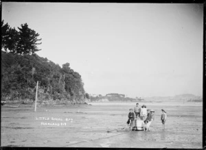 Children in a dinghy on the tidal flat, Little Shoal Bay, Auckland