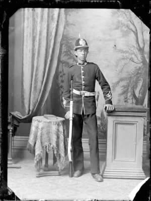 Unidentified man holding rifle, wearing uniform