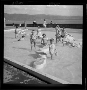 Children playing in a paddling pool, Petone Esplanade