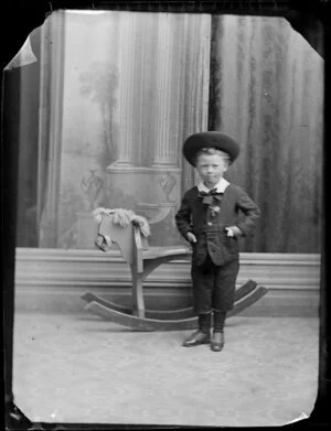 Unidentified boy with rocking horse