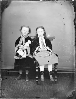 Two unidentified girls and a doll