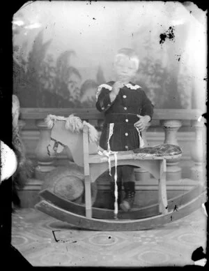 Unidentified child with rocking horse