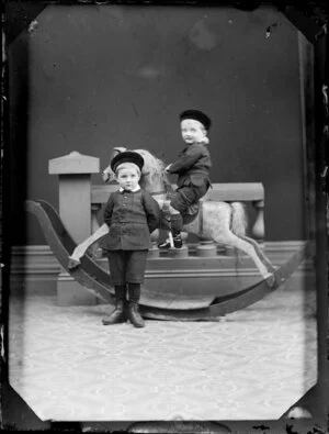 Two unidentified boys and rocking horse