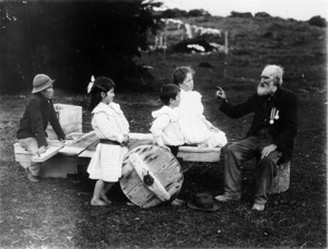 Elderly man with medals talking to children