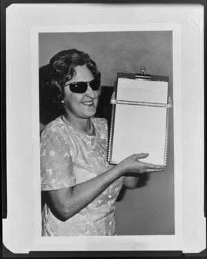 Blind woman holding clipboard