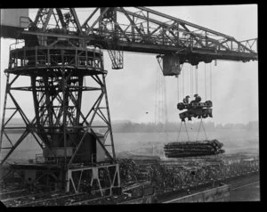 Crane loading logs onto dock, location unidentified