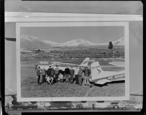 Group of people standing by small planes