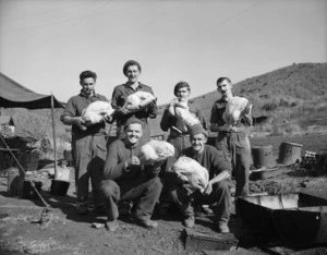 Cooks and assistants of 162 Bty pose with some of the turkeys for the Xmas dinner