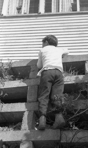 Maori kids climbing concrete wall