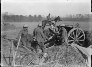 New Zealand soldiers loading a howitzer near Le Quesnoy, France, during World War I