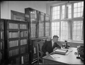 Clyde Taylor, Chief Librarian of the Alexander Turnbull Library, Wellington, in his office