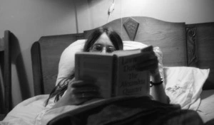 Simone in bed with book