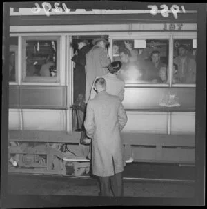 Passengers boarding side door of crowded Wellington tram 197