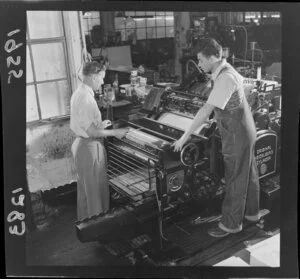 Two men using a printing press, Evening Post, Wellington