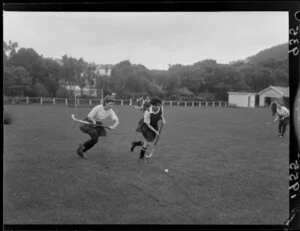 Female field hockey players R Bugden (Wellington Technology Institute) and S Bristor (Konini) pursue the ball during a game