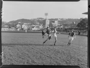 J Metcalfe (Hospital Football Club) playing P Bunney (Seatoun Football Club) in a soccer game, Basin Reserve, Wellington