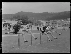 Unidentified young men jumping hurdles at the Junior New Zealand Athletic Championships, Basin Reserve, Wellington