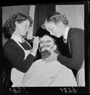 Students applying makeup to Hutt High School performer [Prospero?] in Shakespeare's The Tempest