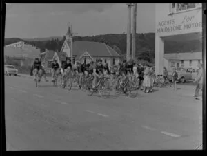 Members of the Upper Hutt Cycling Club riding past a wooden church