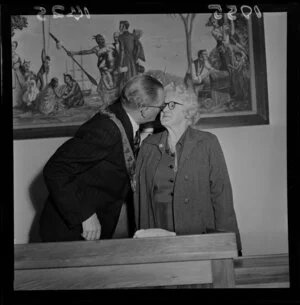 Mayor of Lower Hutt presenting the wife of a councillor with a brooch