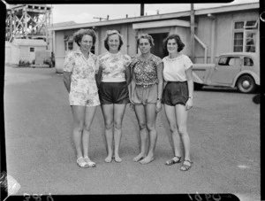 Four women standing outside cabin